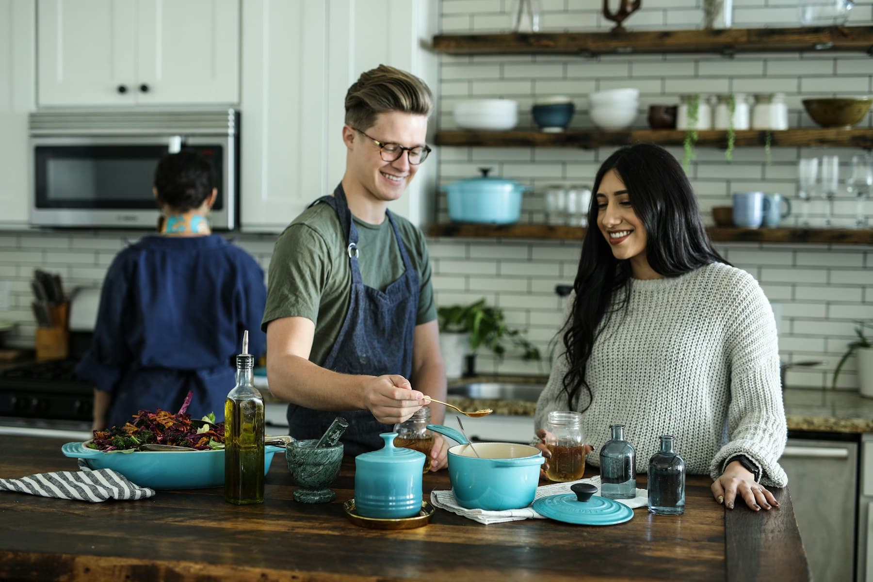 Friends cooking together in a bright home kitchen